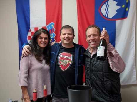 Drava wine staff holding wine bottles and smiling